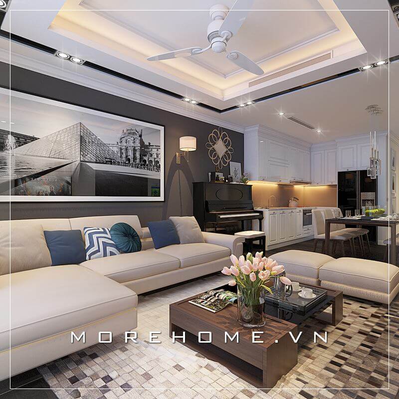 Mẫu thiết kế phòng khách chung cư hiện đại, nổi bật với bức tường màu ghi đậm trong tổng thể gam màu trắng be nội thất, tạo sự đối lập hoàn hảo cuốn hút mọi ánh nhìn