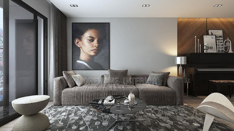 Chiếc sofa dài bằng nỉ màu xám kết hợp chiếc bàn trà màu đen đặt trên chiếc thảm màu xám trắng mang đến không gian mát mẻ Thiết kế nội thất phòng khách chung cư đơn giản